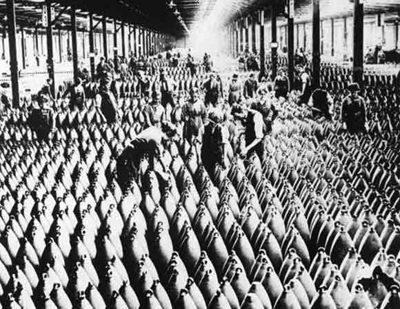 Women working on large shells in a munitions factory in Great Britain.
