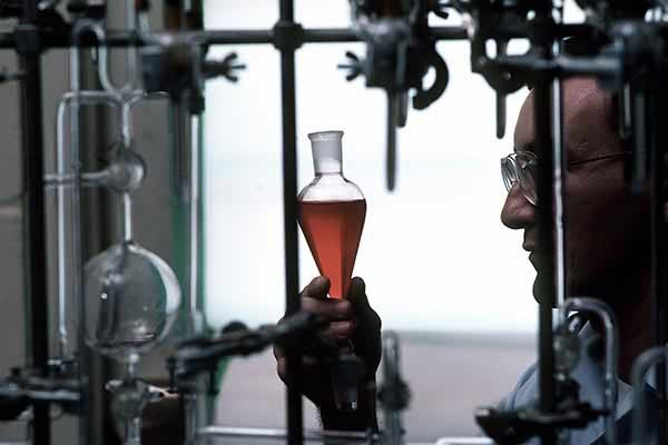 A technician analyzes a chemical liquid for high-explosive research and development. Eglin Air Force Base. 5 January 1980.