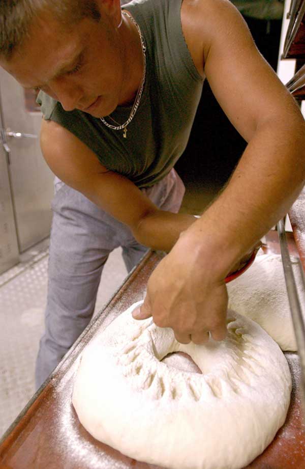 A French Army Soldier assigned to the Field Bakery Unit kneads bread dough during Exercise Bright Star 01/02.