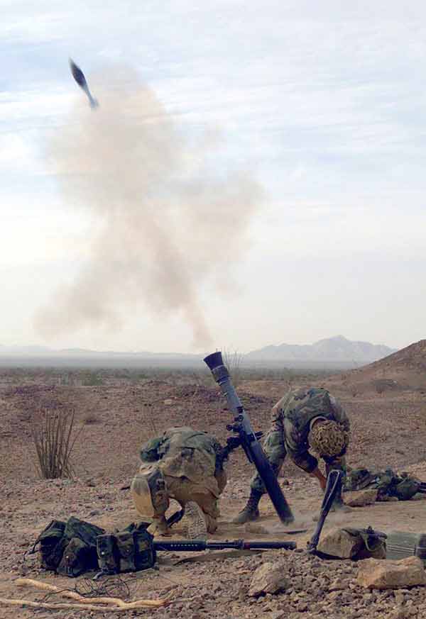 Marines from 81mm Mortar Company 5th Marines stationed at Camp Pendleton, California fire a high explosive round, during a twice yearly Weapons and Tactics Instructor Course, 10/14/2002.
