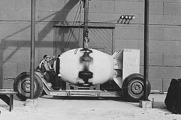 FM (Fat Man) unit being placed on trailer cradle in front of Assembly Building #2, August 1945.